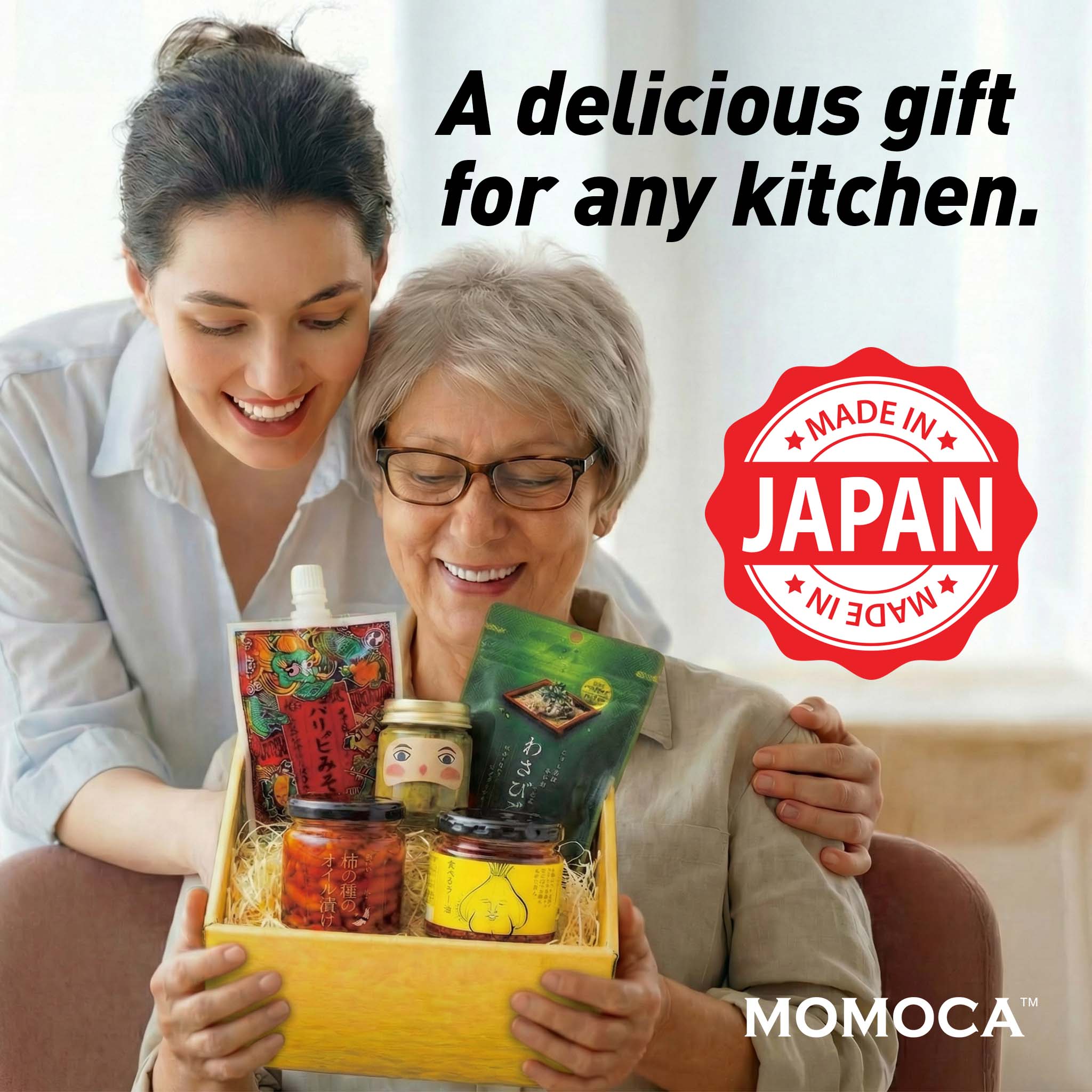 Two women with a gift basket of Japanese products, featuring the 'Made in Japan' label and MOMOCA branding.