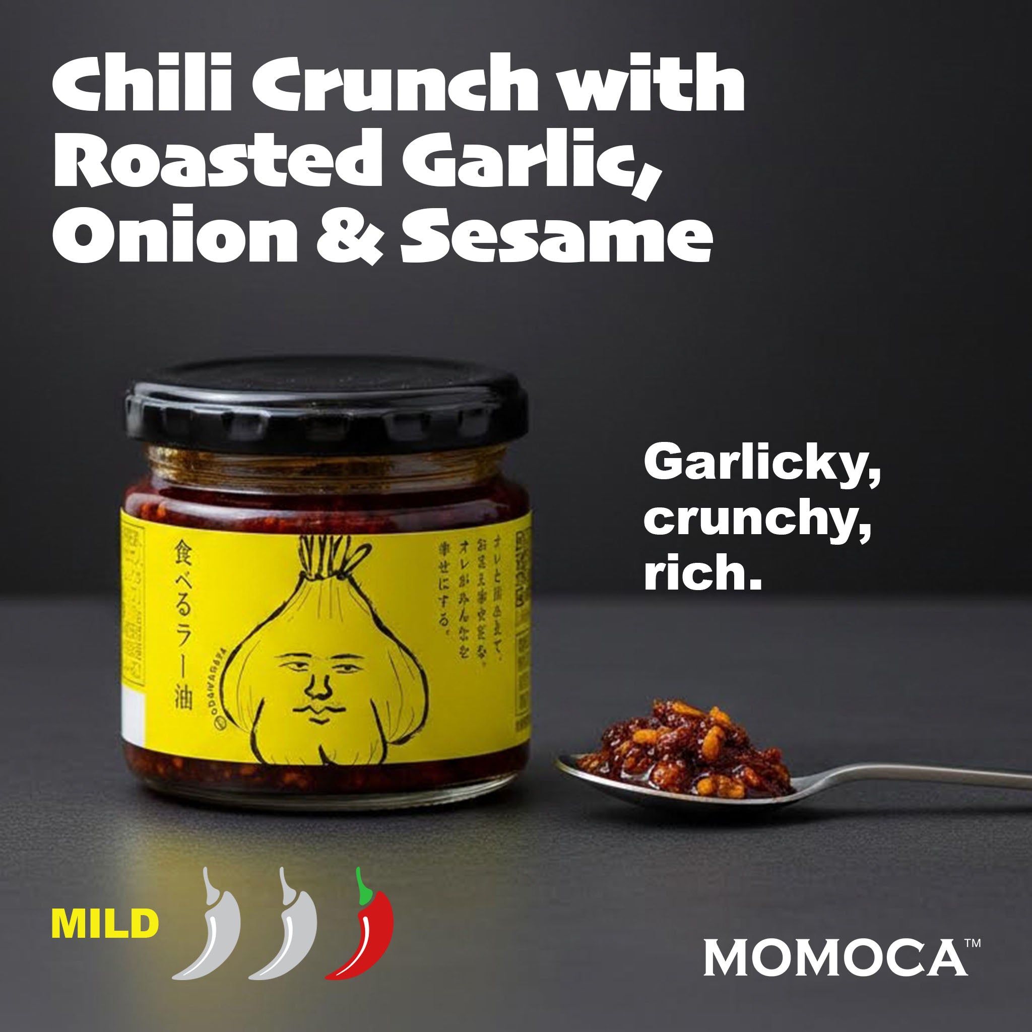 Jar of chili crunch with roasted garlic, onion, and sesame on a dark background, featuring the brand 'MomoCA'.