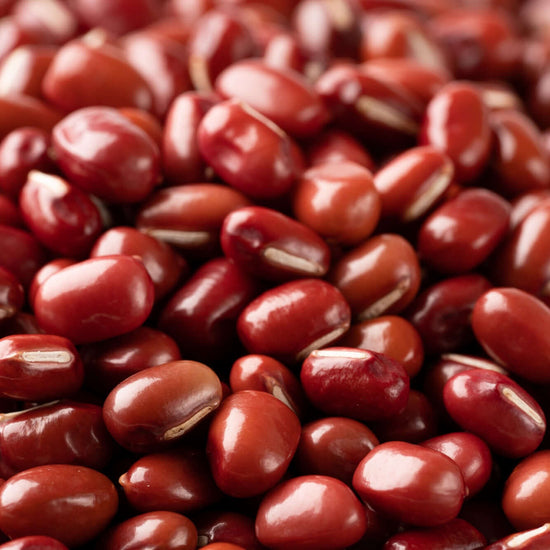 A pile of red beans on a white background, showcasing authentic Japanese snacks.
