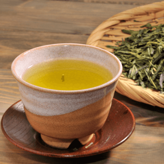 An authentic Japanese cup of green tea on a wooden table.