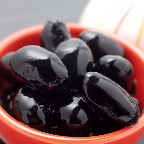 Authentic Japanese snacks with black olives in a red bowl.