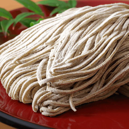 An authentic Japanese snack consisting of a pile of noodles on a red plate.