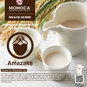 A cup and a jug of creamy drink sit next to a packet labeled "Amazake," highlighting it as the Japanese superfood of the month. Part of the Dream Japanese Snack Box by MOMOCA.