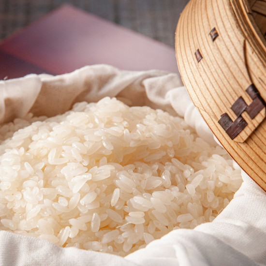 An authentic Japanese snack, rice, is beautifully presented in a basket on a table.