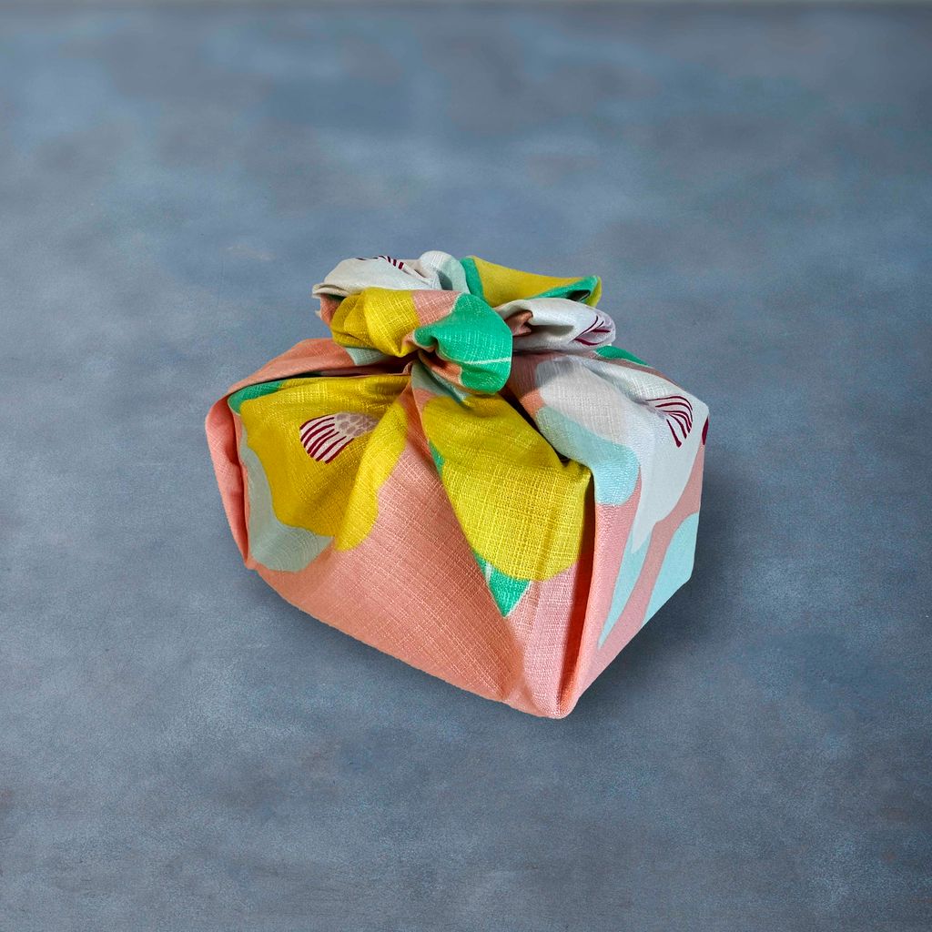Colorful fabric-wrapped gift on a gray background